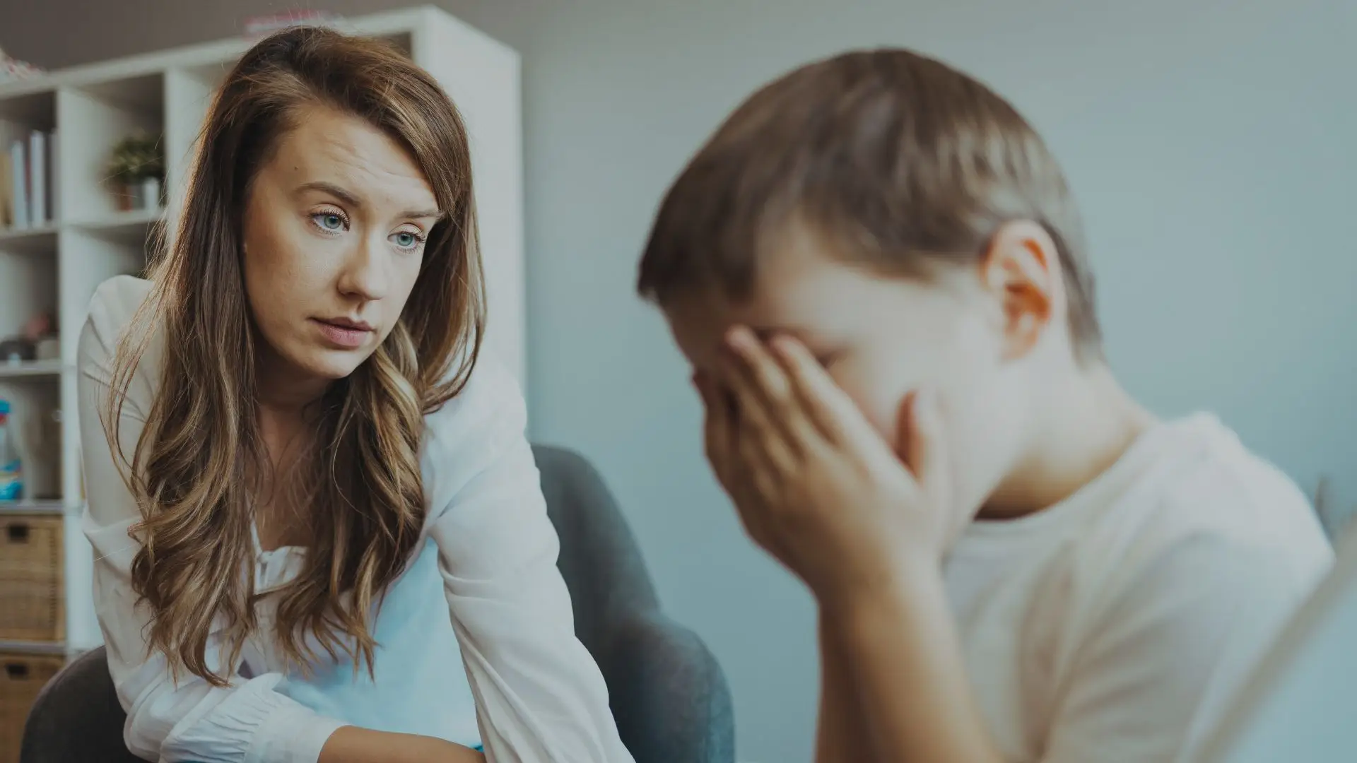 Parent supporting an emotionally overwhelmed child during a difficult moment at home